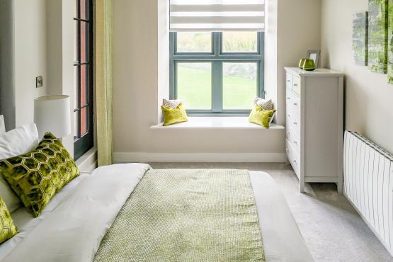 Cosy and bright bedroom with window looking over the garden